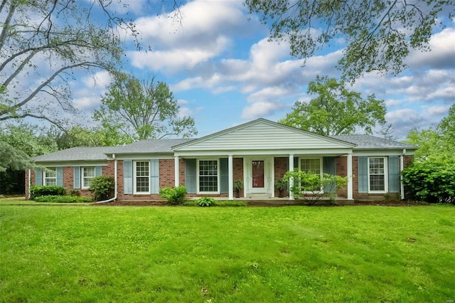single story home with brick siding, covered porch, and a front yard