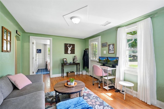 office space with visible vents, baseboards, and wood finished floors