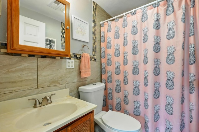 bathroom with visible vents, tile walls, curtained shower, vanity, and toilet