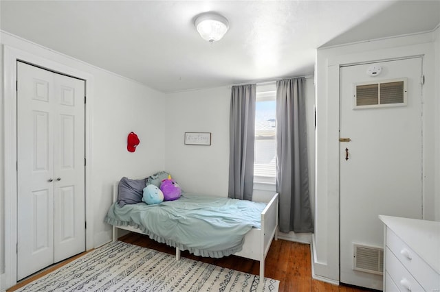 bedroom with visible vents and wood finished floors
