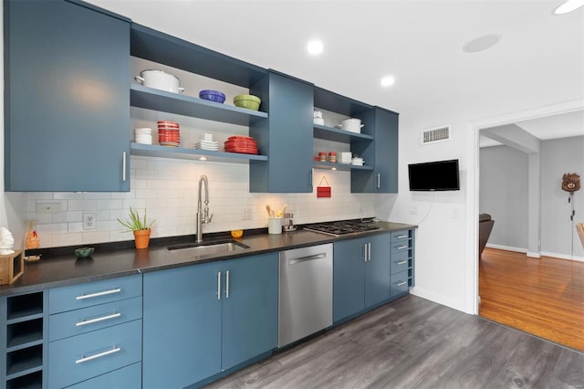 kitchen featuring a sink, blue cabinets, open shelves, visible vents, and appliances with stainless steel finishes