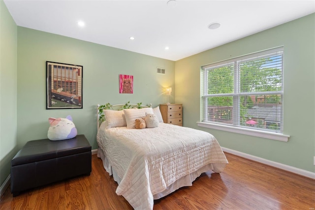 bedroom featuring recessed lighting, baseboards, visible vents, and wood finished floors