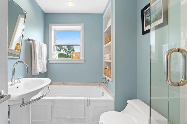 bathroom featuring a stall shower, toilet, a sink, and a bath