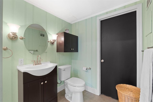 bathroom with toilet, vanity, ornamental molding, tile patterned flooring, and baseboards