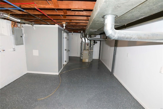 unfinished basement featuring baseboards, heating unit, and electric panel