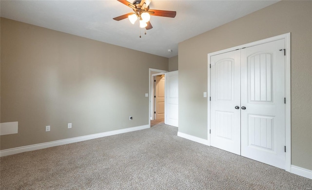unfurnished bedroom with carpet floors, baseboards, ceiling fan, and a closet