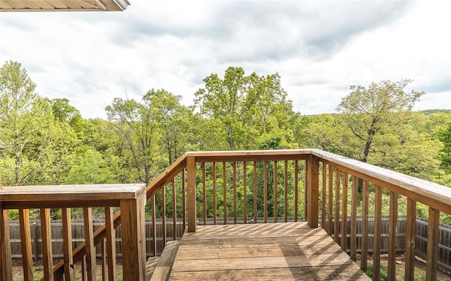 wooden deck featuring a view of trees