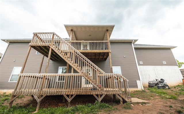 rear view of property with a deck and stairway