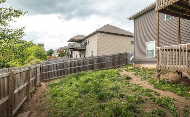 view of yard featuring a wooden deck and a fenced backyard