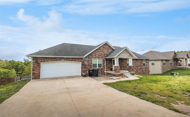 craftsman-style house with a garage, fence, a front yard, brick siding, and concrete driveway