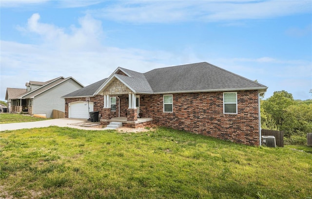 view of front of home with a front lawn, brick siding, a shingled roof, an attached garage, and driveway