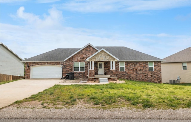 view of front of home with concrete driveway, cooling unit, roof with shingles, and a garage
