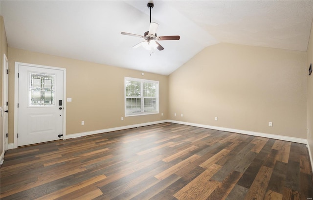 unfurnished living room featuring dark wood-style flooring, a ceiling fan, baseboards, and vaulted ceiling