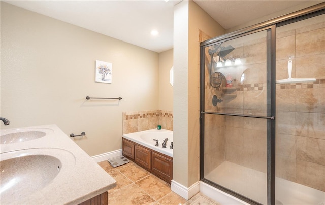full bathroom featuring a garden tub, a sink, baseboards, and a stall shower