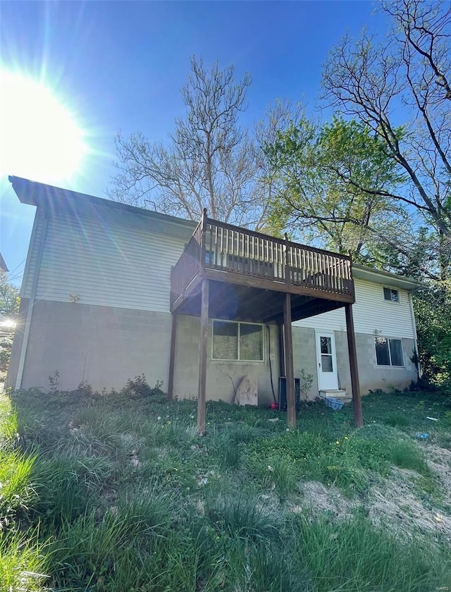 back of house featuring a deck