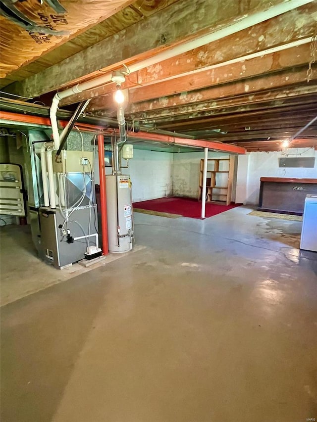 unfinished basement featuring water heater, heating unit, and washer / clothes dryer
