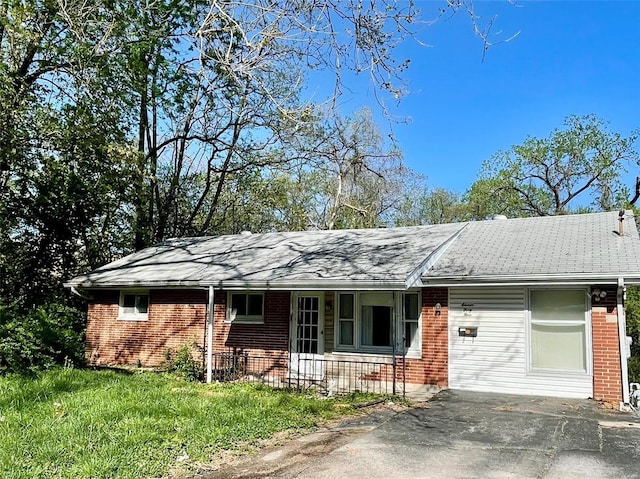 single story home with a porch and brick siding