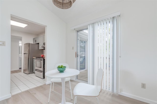 dining area featuring a healthy amount of sunlight, baseboards, and light wood-type flooring