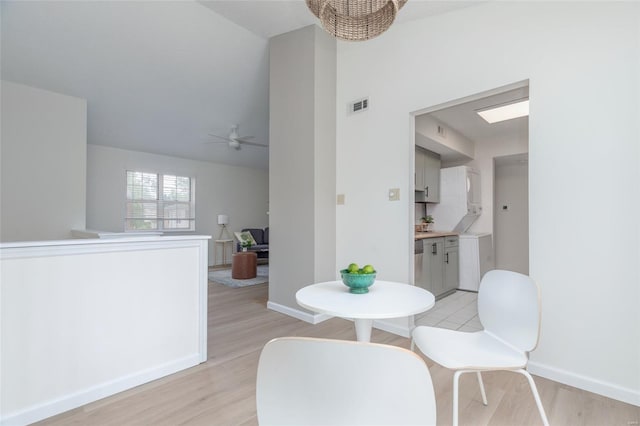 dining area with baseboards, ceiling fan, light wood-type flooring, and visible vents