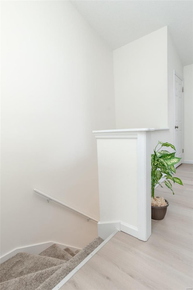 stairs featuring baseboards and wood finished floors
