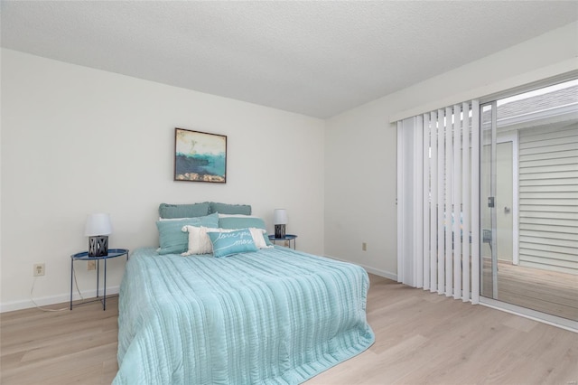 bedroom with baseboards and wood finished floors