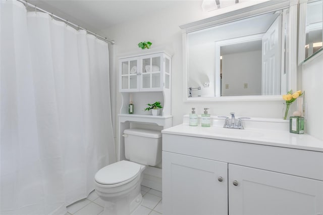bathroom with toilet, curtained shower, tile patterned flooring, and vanity
