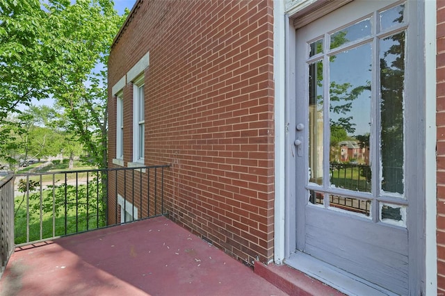 doorway to property featuring brick siding