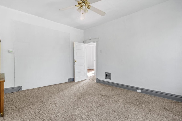 carpeted spare room featuring a ceiling fan