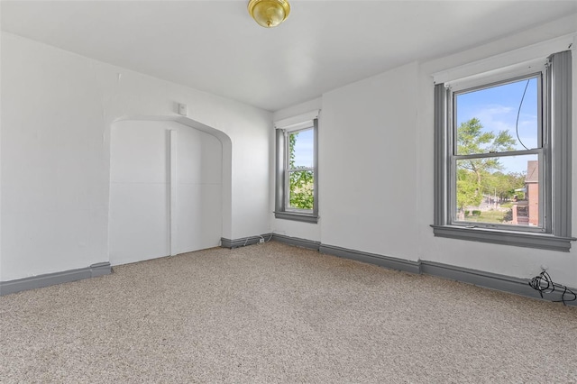 carpeted spare room with baseboards