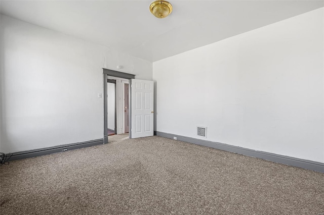 unfurnished room featuring carpet floors, baseboards, and visible vents