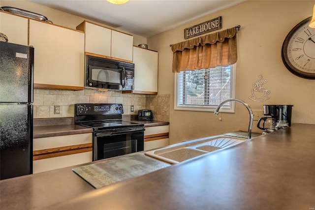 kitchen with dark countertops, decorative backsplash, a sink, and black appliances
