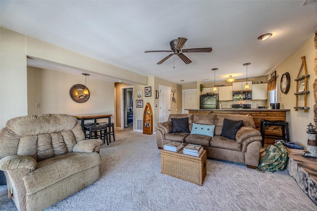 living room featuring a ceiling fan and light carpet