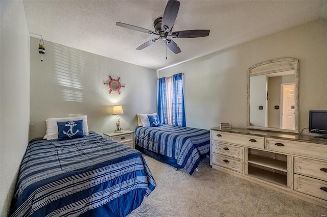 carpeted bedroom with a ceiling fan and a textured ceiling