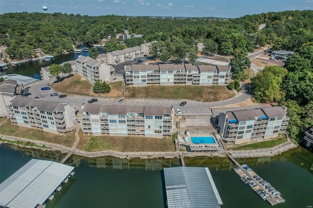 drone / aerial view featuring a water view and a wooded view