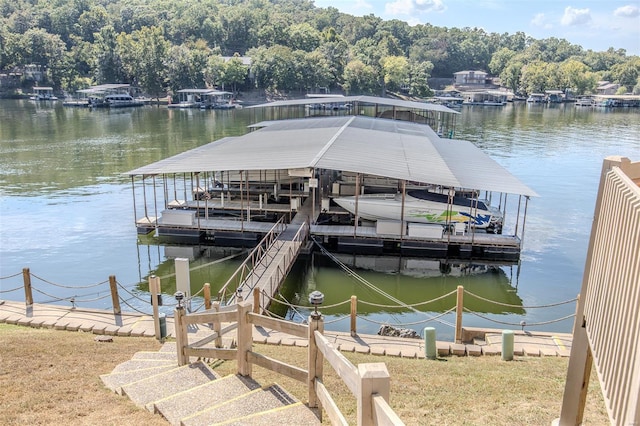 view of dock with boat lift and a water view