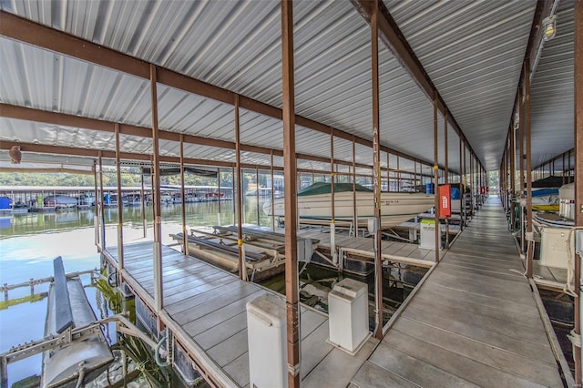 dock area featuring boat lift and a water view