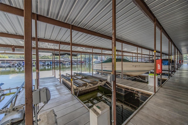 dock area featuring boat lift and a water view