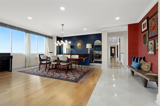 dining room with an inviting chandelier, ornamental molding, light tile patterned flooring, baseboards, and recessed lighting