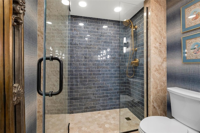 bathroom featuring a shower stall and toilet