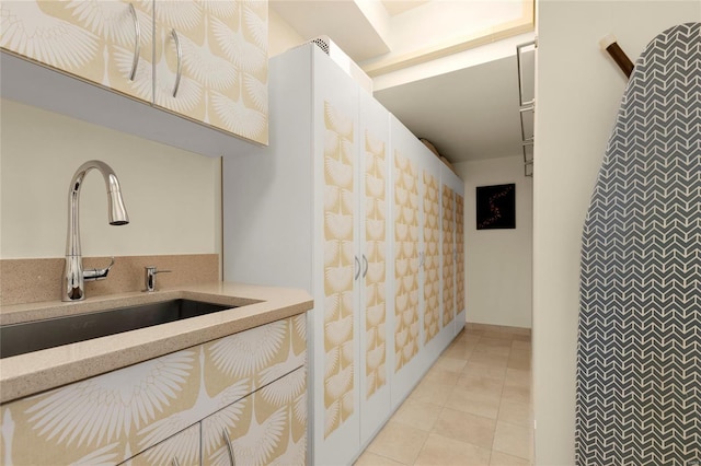 interior space with a sink and light tile patterned flooring