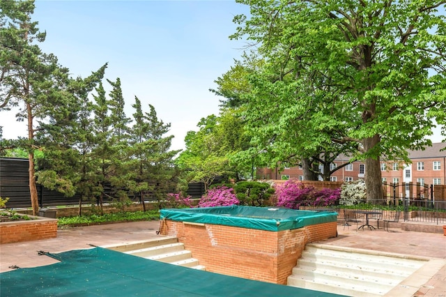 exterior space featuring a swimming pool, fence, and a patio