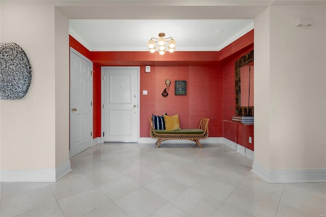 entryway with crown molding, baseboards, light tile patterned floors, and a chandelier