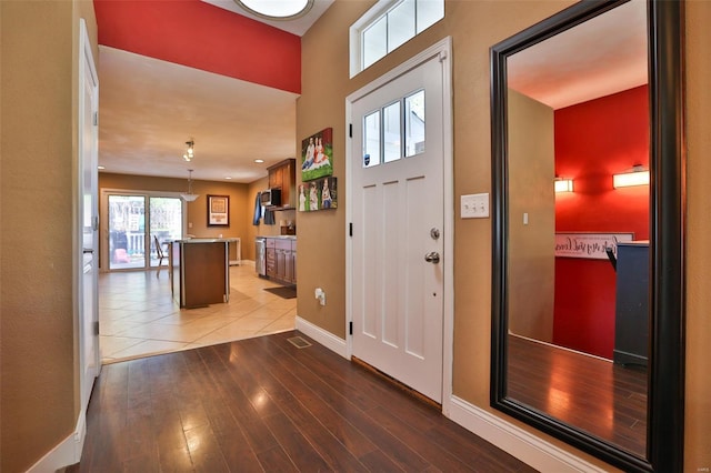 foyer entrance featuring light wood-style floors and baseboards