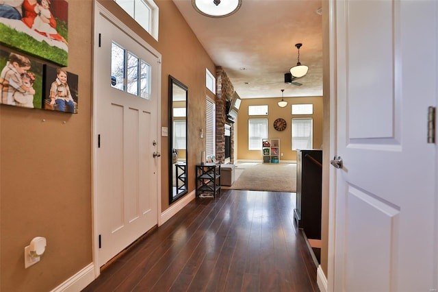 foyer entrance with baseboards, dark wood-style flooring, and plenty of natural light