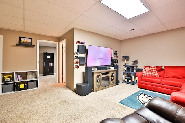carpeted living room with a drop ceiling