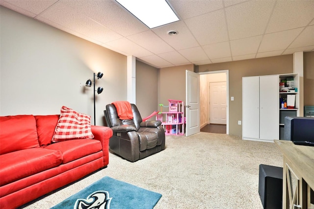 carpeted living room featuring a paneled ceiling