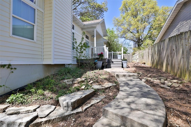 exterior space with fence and covered porch