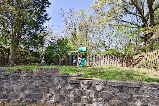 view of yard with a fenced backyard and a playground