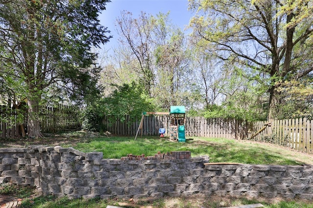 view of yard with a fenced backyard and a playground