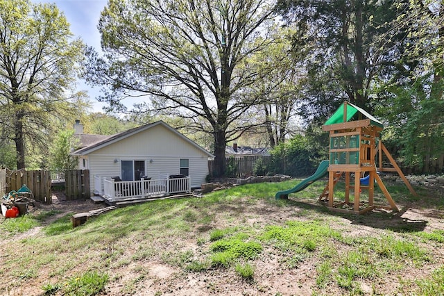 view of yard featuring a playground and fence